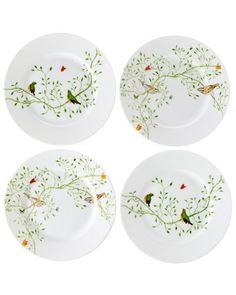 four white plates with birds on them