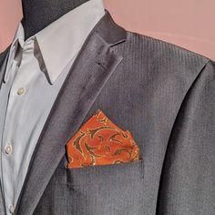 "Let your outfit shine with this glittery print. This fabric features elegant gold vine on top of Orange fabric. I do my best to remove any excess  glitter, but keep in mind it is a gliter.  The pre-folded pocket squares are mounted on a card that can be cut down to your desired depth. The fold style can't be changed. This pocket square is available only with the pre-folded styles as shown in the pictures. The purchase of this listing is for one pre-folded pocket square with the following specifications:  Style:  two peaks Colors: Sparkling Gold Vines on Orange, more colors available, see links below.  Material:  100% Polyester. Measurements:  Handkerchief:W:3.5\" (8.9cm) x L:2.5\"(6.35cm) Pocket square card measures W:3.5\"(8.9cm) x L:4.5\"(11.43cm) stock 09/17 Red: https://didiartcorner. African Print Pocket Square, Gold Pocket Square, Orange And Gold, The Fold, Orange Fabric, Square Card, Pocket Squares, White Box, Tie Accessories