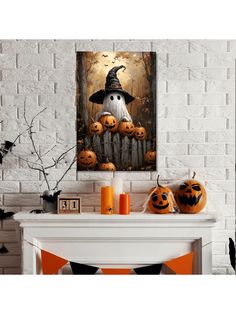 a white fireplace with pumpkins and a painting on it