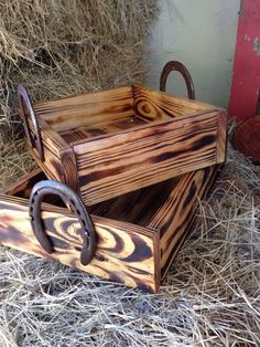 two wooden boxes sitting on top of hay