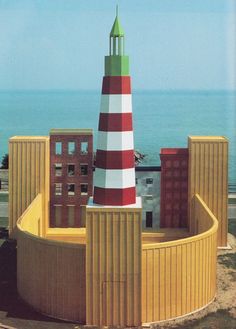 a model of a lighthouse on top of a building next to the ocean