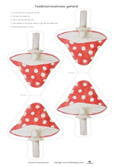 four red mushrooms with white dots on them are cut out from paper and placed in the shape