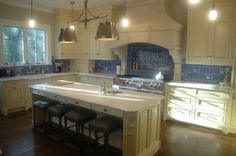 a large kitchen with an island in the middle