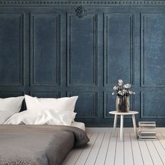 a bedroom with blue walls and white bedding in the center, along with a small side table