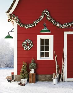 a red house decorated for christmas with wreaths and lights