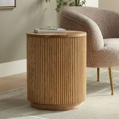 a chair and table in a room with a rug on the floor next to it