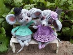 two crocheted mice sitting on top of a bench