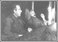 black and white photograph of two men sitting next to each other