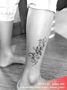 a woman with a tattoo on her leg and foot is shown in black and white