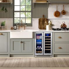 a kitchen with gray cabinets and white counter tops, an open wine cooler in the center