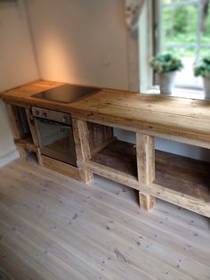 an entertainment center made out of pallet wood with two ovens on each side