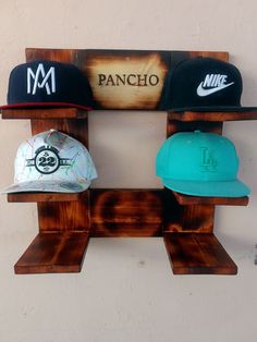 three hats are hanging on a rack with the word pancho written in spanish and another hat is below it