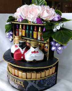 there is a vase with flowers and bottles on it