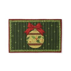 a christmas ornament door mat with a red bow on the front and green background