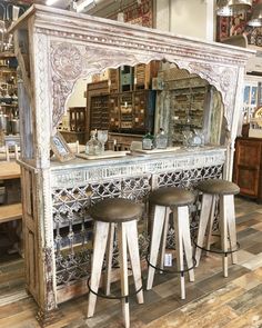 an antique store display with stools and mirrors