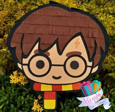 a paper cut out of harry potter holding a toothbrush in front of some flowers