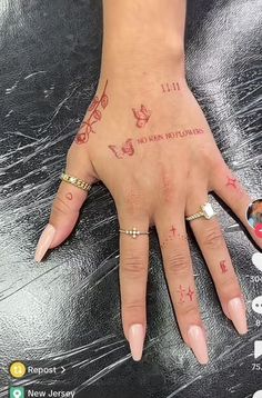 a woman's hand with tattoos on it and the words i love you written in red ink