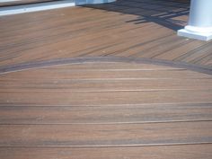 a cat sitting on top of a wooden deck