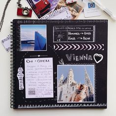 an open notebook with pictures and writing on the pages next to a pen, camera, keys, and other items