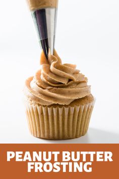 a cupcake being frosted with peanut butter frosting