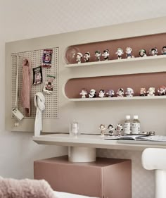 a bedroom with shelves above the bed and toys on the wall