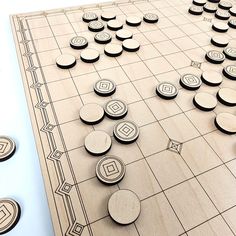 a wooden board game set up on top of a tile floor with circles and squares