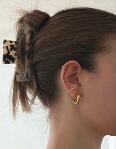 a close up of a person with a hair clip in the shape of a bow