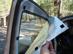 someone is cleaning the windshield of their car with a cloth on it's side window