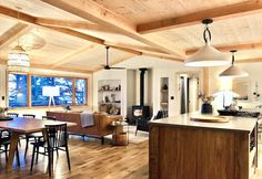 a kitchen and living room are shown in this open concept home with wood flooring