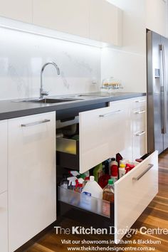 an open drawer in the middle of a kitchen