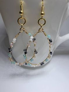 These delicate beaded wire hoops are attached to 18k gold plated brass ear wires that are nickel free. The tiny faceted glass beads are black, champagne, white, and minty green. This color combo lends itself to multiple oufit pairings making this a versatile accessory. Hoop Bead Earrings, Earrings Making, Minty Green, Beaded Jewellery, Beads Earrings, Wire Work Jewelry, Earrings Inspiration, Work Jewelry, Handmade Wire Jewelry