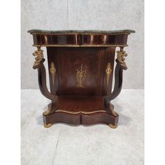 an ornate wooden table with marble top