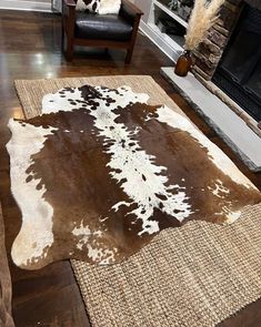 a brown and white cowhide rug in a living room