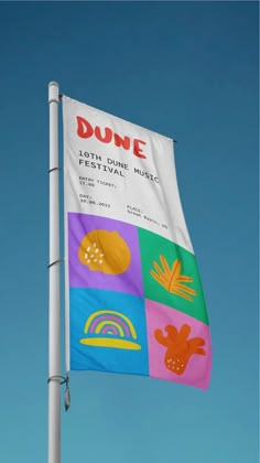 a flag with the words dune on it flying high in the blue sky next to a white pole