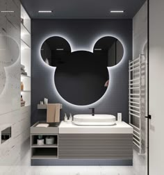 a bathroom with a sink, mirror and mickey mouse head on the wall above it