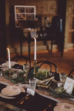 the table is set with candles and place settings