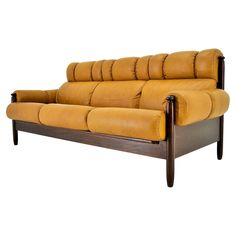 a brown leather couch sitting on top of a wooden frame