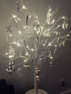 a lighted tree with many ornaments on it