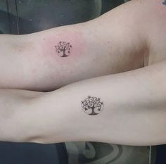 two people with tattoos on their arms and one has a tree tattoo on his arm