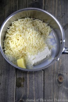 cheese and butter in a saucepan on a wooden table