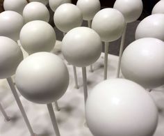 many white balls and sticks are on display