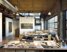 an empty room with lots of clutter on the floor and tables in front of large windows