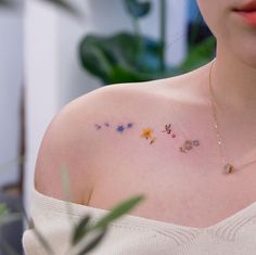 a woman's chest with small flowers on it