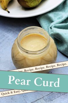 pear curd in a jar on a plate with two pears next to it