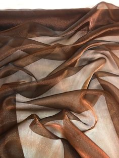 "TWO TONE BROWN ORGANZA FABRIC Product information 1 mtr two tone brown organza fabric 58\" wide 147cm Organza fabric is lightweight. It has a outstanding drape and is often used by tailors to creat dresses and skirts with volume Ideal for decorations,dress making,bridal,table runners,crafts, drapery,decorations,gift bags and many other projects Sold by the mtr If more than one quantity is bought it will be sent as one continous length" King Costume, Pink Wedding Theme, Bridal Table, Beaded Tulle, Bridal Fabric, Net Fabric, Organza Fabric, Brocade Fabric, Aztec Print