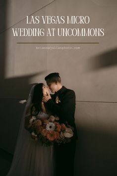 a bride and groom kissing in front of a wall with the words las vegas micro wedding at uncommonions