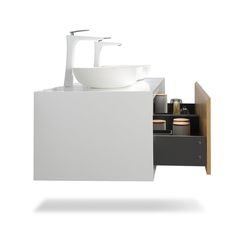 a white sink sitting next to a cabinet under a faucet in a bathroom