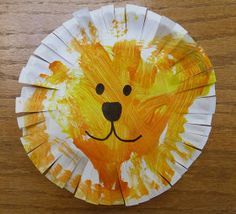 a paper plate with a lion face painted on it