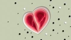 two paper cut out hearts on a green background with black and white polka dotes