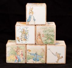 a stack of wooden blocks with peter rabbit pictures on the front and sides, all stacked up